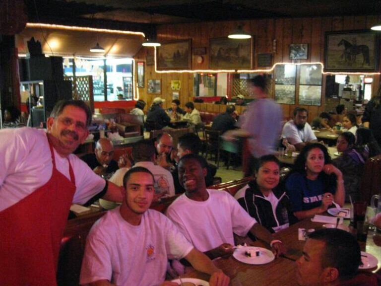 Guests filling the wood-paneled Bravo Pizza dining room