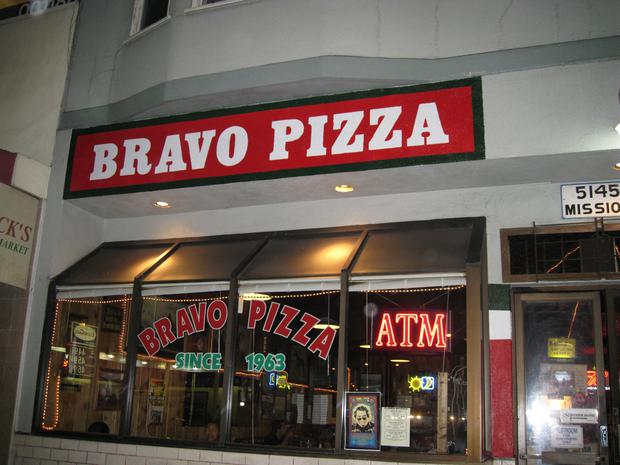 Bravo Pizza storefront at night on Mission Street, with Since 1963 lettered on the window