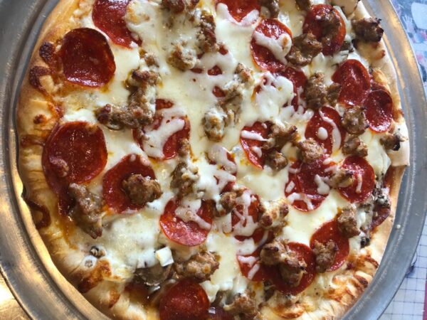 World Famous Bravo Pizza topped with pepperoni, sausage, salami, mushrooms and onions